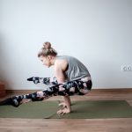 a woman is doing a yoga pose on a mat